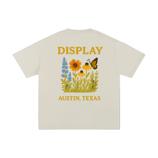 Beige t-shirt with floral design and text on a white background